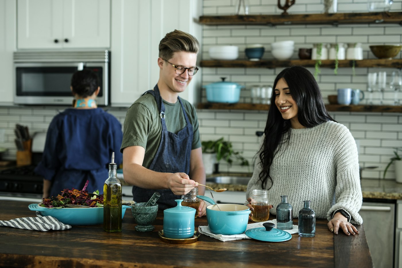 Two young adults cooking together in a shared kitchen