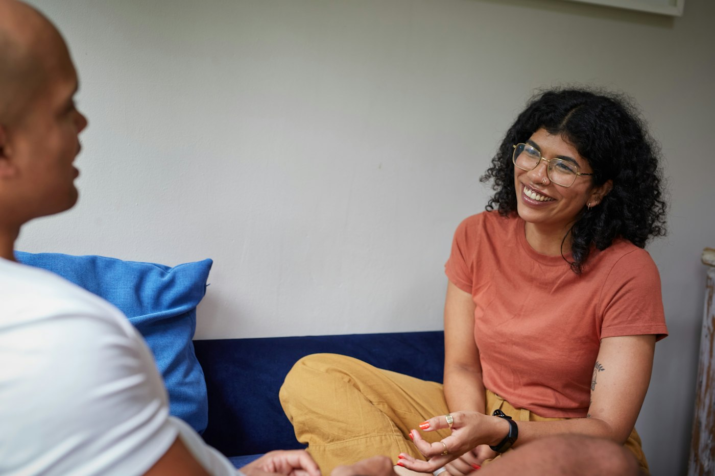 A young woman smiling during a one-to-one conversation with a support worker